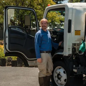 technician standing outside company vehicle